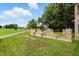 Landscape design featuring stone fence with lush lawn at 7843 E Triple Crown Ln, Camby, IN 46113