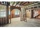 Unfinished room featuring exposed wood framing, open doorway and staircase awaiting personal design at 7843 E Triple Crown Ln, Camby, IN 46113