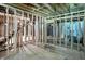 Unfinished space revealing open framing, electrical wiring, and staircase with an unfinished ceiling at 7843 E Triple Crown Ln, Camby, IN 46113