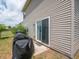 Exterior sliding glass doors lead to a well-maintained backyard with lush grass at 8125 Whistlewood Dr, Indianapolis, IN 46239