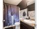 Unique bathroom with a themed shower curtain, modern vanity, and dark accents, offering a stylish design at 8125 Whistlewood Dr, Indianapolis, IN 46239