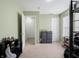 Bedroom with neutral carpet, light green walls, and a doorway to the hallway at 8125 Whistlewood Dr, Indianapolis, IN 46239