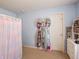 Bedroom featuring a blue wall, neutral carpet, and accessories like a backpack rack and white shelving at 8125 Whistlewood Dr, Indianapolis, IN 46239
