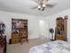 Bedroom featuring a wooden desk, display cabinet, and fan, perfect for a functional and comfortable space at 8125 Whistlewood Dr, Indianapolis, IN 46239