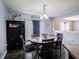 Cozy dining room with a round table, six chairs, and a decorative cabinet creating a warm ambiance at 8125 Whistlewood Dr, Indianapolis, IN 46239