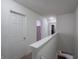 Bright hallway featuring neutral colors, white trim, and access to bedrooms with a view of the living space at 8125 Whistlewood Dr, Indianapolis, IN 46239