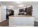 Open kitchen layout with dark cabinetry, a center island with a sink, and modern appliances at 8125 Whistlewood Dr, Indianapolis, IN 46239