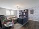 Open concept living room with cozy seating, a large TV console, and decorative wallpaper for a modern touch at 8125 Whistlewood Dr, Indianapolis, IN 46239