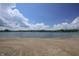 Peaceful beachfront view of a serene lake with a sandy shore and beautiful sky at 8167 Center Lake Rd, Nineveh, IN 46164