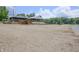 Sandy beach area with covered pavilions and lifeguard equipment under a partly cloudy sky at 8167 Center Lake Rd, Nineveh, IN 46164