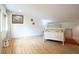 Well-lit bedroom with wood floors, a white bed frame, and decor at 8167 Center Lake Rd, Nineveh, IN 46164