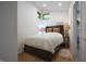 Cozy bedroom featuring a wooden headboard, bedside lamps, and a small window with natural light at 8167 Center Lake Rd, Nineveh, IN 46164