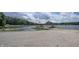 Gravel driveway leading to a boat dock with boat lifts on a calm lake setting at 8167 Center Lake Rd, Nineveh, IN 46164