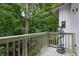An exterior shot of a deck surrounded by lush green trees at 8167 Center Lake Rd, Nineveh, IN 46164