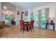 Dining area features wood floors, wood stove, vaulted ceiling and sliding doors to an outdoor deck at 8167 Center Lake Rd, Nineveh, IN 46164