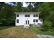 Charming two-story home with a white exterior, front deck, and surrounded by lush trees at 8167 Center Lake Rd, Nineveh, IN 46164