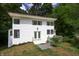 Charming two-story home with a white exterior, front deck, and surrounded by lush trees at 8167 Center Lake Rd, Nineveh, IN 46164
