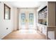 Bright foyer featuring hardwood floors, a stylish cabinet, and a decorative glass front door at 8167 Center Lake Rd, Nineveh, IN 46164