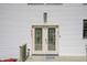 Exterior view of the charming front door with decorative glass and a welcoming entrance mat at 8167 Center Lake Rd, Nineveh, IN 46164