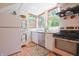 Bright kitchen with stainless appliances, white cabinetry, wood floors, hanging rack and lots of natural light at 8167 Center Lake Rd, Nineveh, IN 46164