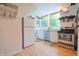 Bright kitchen features stainless steel appliances, wood floors, natural light and white cabinetry at 8167 Center Lake Rd, Nineveh, IN 46164