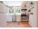 Bright kitchen features stainless steel appliances, wood floors, natural light, white cabinetry, and hanging rack at 8167 Center Lake Rd, Nineveh, IN 46164