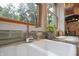 Close up of the kitchen sink features granite countertops, wood frame windows and lots of natural light at 8167 Center Lake Rd, Nineveh, IN 46164