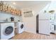 Efficient laundry area with a washer, dryer, and storage in the connected kitchen space at 8167 Center Lake Rd, Nineveh, IN 46164
