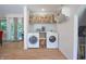 Bright laundry area with modern appliances, convenient counter space, and storage shelving at 8167 Center Lake Rd, Nineveh, IN 46164