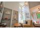 Living room with built-in shelving, vaulted ceilings, and multiple windows at 8167 Center Lake Rd, Nineveh, IN 46164