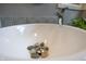 Close-up of a vessel sink with decorative stones, a modern faucet, and muted gray tiling at 8167 Center Lake Rd, Nineveh, IN 46164
