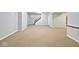 Spacious basement features neutral carpet and stairs to the upper level at 8909 Carnation Dr, Noblesville, IN 46060