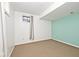 Basement room featuring neutral carpeting and a light aqua accent wall at 8909 Carnation Dr, Noblesville, IN 46060