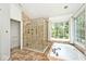 Luxurious bathroom with a glass-enclosed shower and a soaking tub by a large window at 8909 Carnation Dr, Noblesville, IN 46060