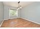 Dining room featuring hardwood floors, large windows, and modern lighting at 8909 Carnation Dr, Noblesville, IN 46060