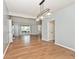 Open concept dining room with hardwood floors, modern lighting, and an entryway at 8909 Carnation Dr, Noblesville, IN 46060
