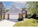 Charming two-story brick home boasts a well-manicured lawn, three car garage, and lovely curb appeal at 8909 Carnation Dr, Noblesville, IN 46060