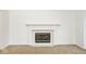 Elegant fireplace with decorative mantle, carpet, and white walls creates a focal point at 8909 Carnation Dr, Noblesville, IN 46060