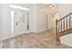 The bright foyer has tile floors, a decorative door, and a staircase at 8909 Carnation Dr, Noblesville, IN 46060