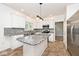 Kitchen with an island, granite countertops, stainless-steel appliances, and white cabinets at 8909 Carnation Dr, Noblesville, IN 46060