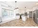 Bright kitchen features stainless steel appliances, granite countertops, tile floors, and a welcome sign at 8909 Carnation Dr, Noblesville, IN 46060