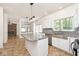 Bright kitchen with an island, white cabinets, granite countertops, and stainless-steel appliances at 8909 Carnation Dr, Noblesville, IN 46060