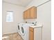 Functional laundry room featuring modern washer and dryer and convenient storage at 8909 Carnation Dr, Noblesville, IN 46060