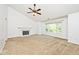 Cozy living room with a fireplace, carpet, fan, and large windows at 8909 Carnation Dr, Noblesville, IN 46060