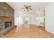 Spacious living room with hardwood floors, brick fireplace, ceiling fan, and natural light at 8909 Carnation Dr, Noblesville, IN 46060