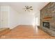 Living room with brick fireplace, hardwood floors, white walls, and natural light at 8909 Carnation Dr, Noblesville, IN 46060
