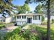 Cozy one-story home featuring black shutters, a garage and a small front yard with a pathway at 906 Hemlock St, Shelbyville, IN 46176