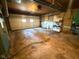 Spacious garage with garage door, shelving, and mechanicals at 906 Hemlock St, Shelbyville, IN 46176
