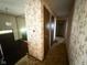 Hallway with vintage bamboo wallpaper, carpet, wood doors and trim, and access to an upstairs area at 906 Hemlock St, Shelbyville, IN 46176