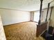 Spacious living room with carpet, vintage curtains, and wood trim at 906 Hemlock St, Shelbyville, IN 46176
